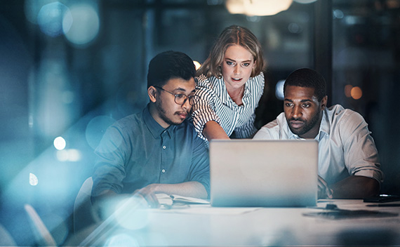 Three business poeple looking at computer