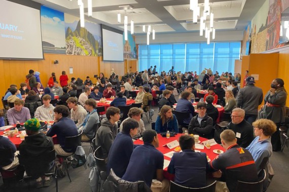 Picture of students talking and sitting at round tables