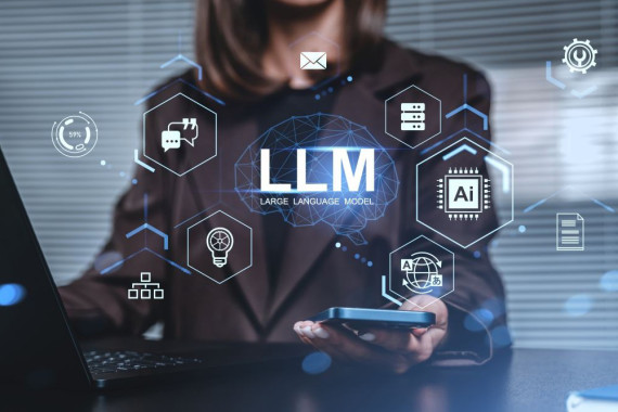 Business professional using a laptop and smartphone with digital graphics showing “LLM – Large Language Model” and AI-related icons around a brain illustration.