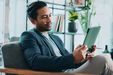 Businessman looking at a tablet in an office workspace