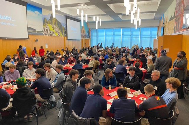 Picture of students talking and sitting at round tables