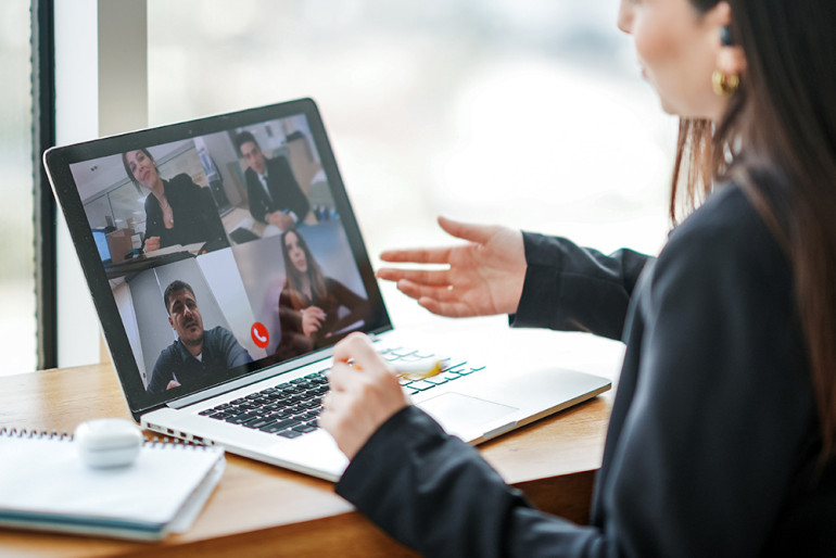 Person participating in an online meeting on their laptop